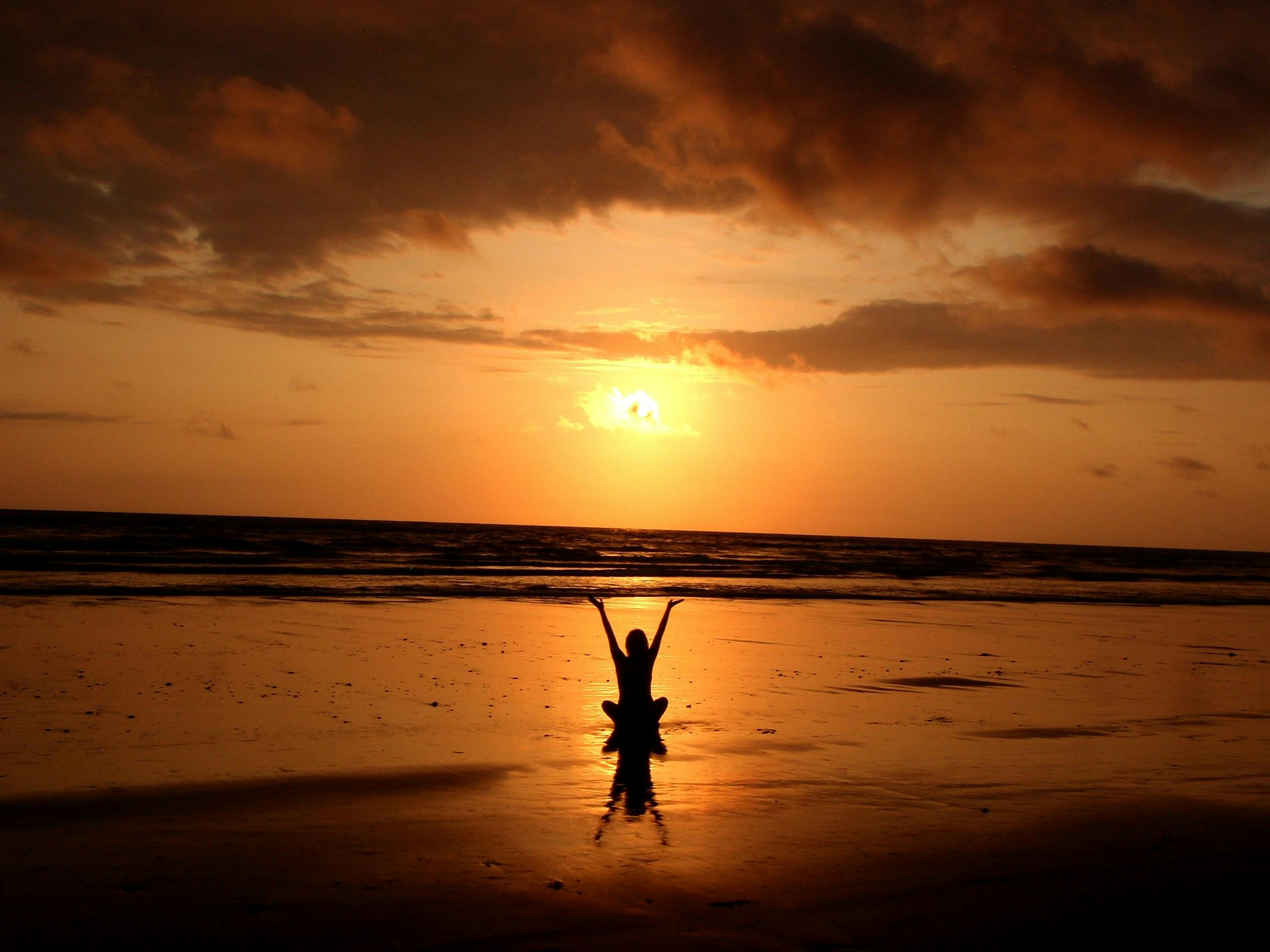Peaceful meditation silhouette at sunset on a serene beach. Meditation for beginners