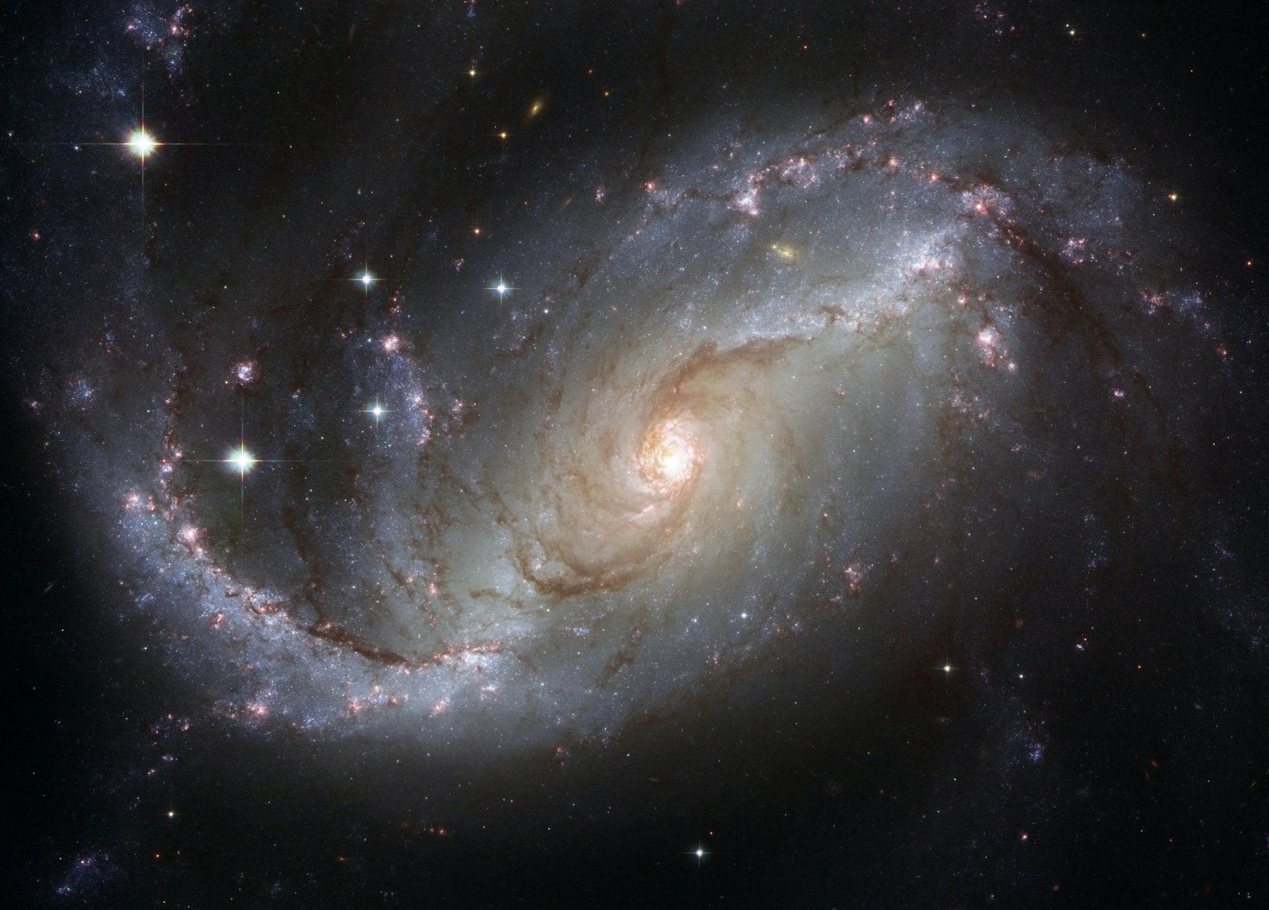 Capture of the NGC 1672 spiral galaxy showcasing its majestic spiral arms and bright core representing the 12 Universal Laws.